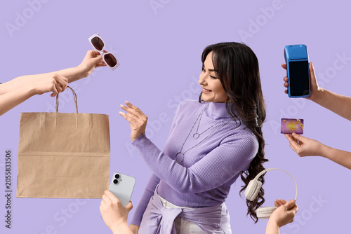 Beautiful woman and female hands holding shopping bag with gadgets on lilac b...