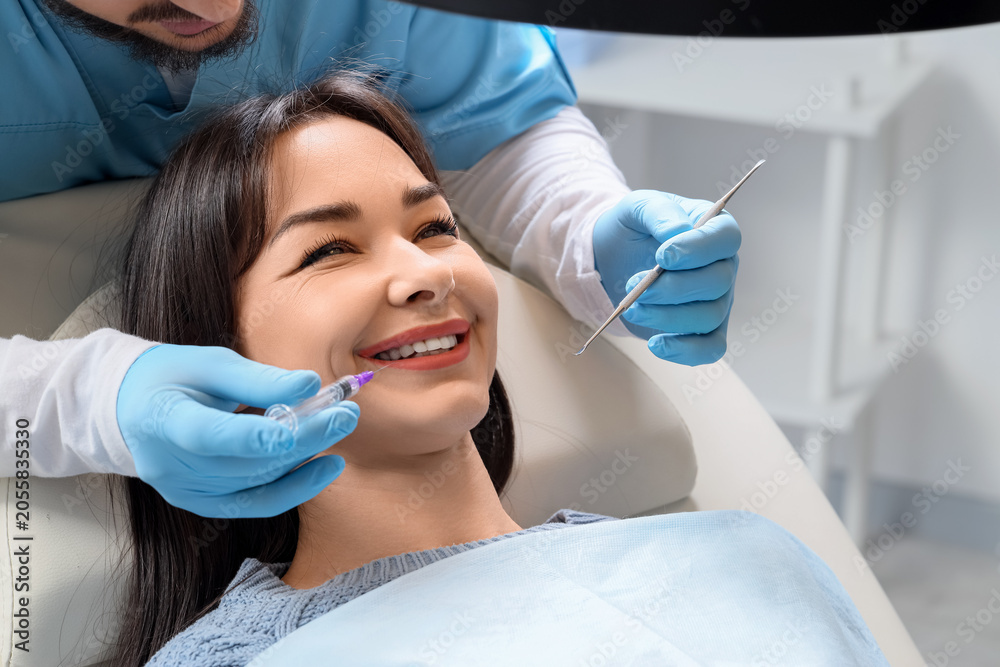 Fototapeta premium Young woman visiting dentist in clinic, closeup