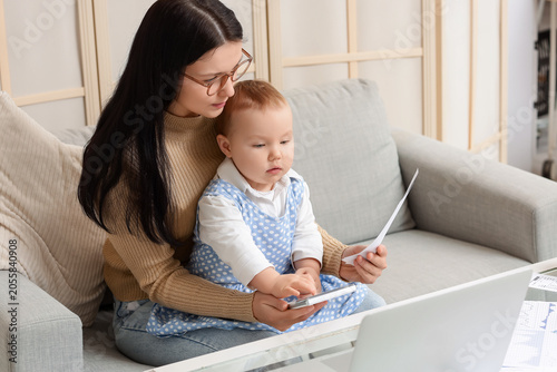 Young mother with calculato...