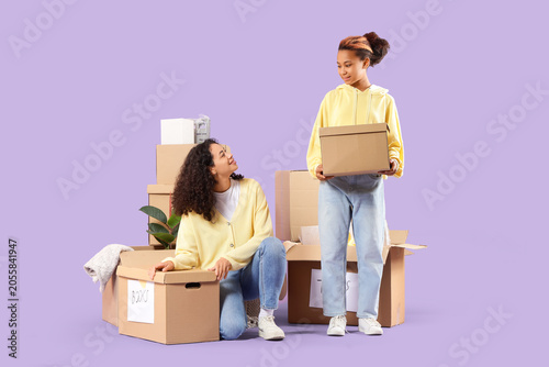 Two young women moving into...