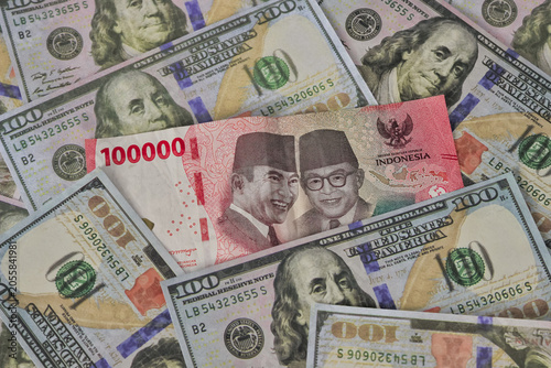 Illustration of depreciation Indonesian Rupiah banknote and US Dollar bills for currency exchange. depreciation money for finance concept with detail shot