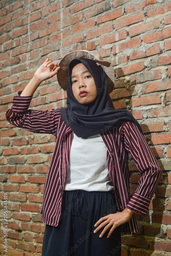 Naklejka premium Young Asian woman model with hat and red dress