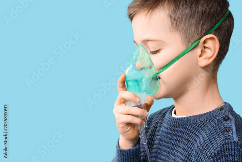 Little boy using nebulizer ...