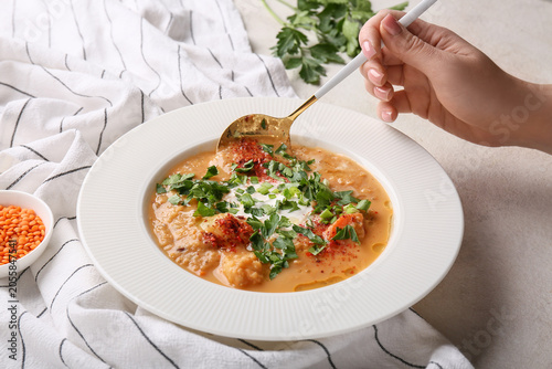 Female hand with spoon and ...