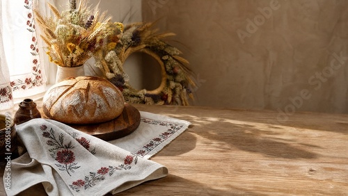Vyshyvanka embroidered napkin with round bread and wildflower wreath, Ukrainian culinary concept. menu design.