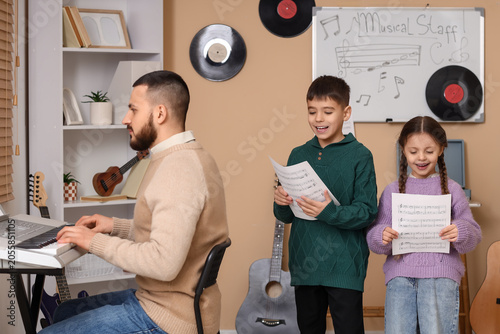 Music teacher playing elect...