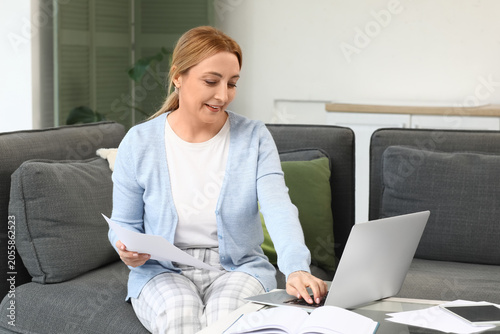 Smiling woman working remot...