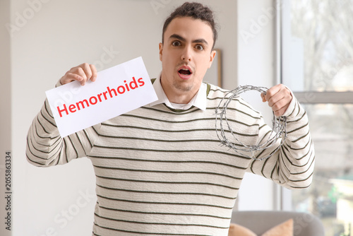 Man holding hemorrhoids sig...
