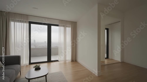 Empty modern apartment interior with large glass door.