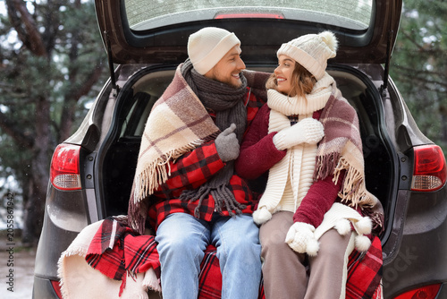 Young couple with plaid sit...