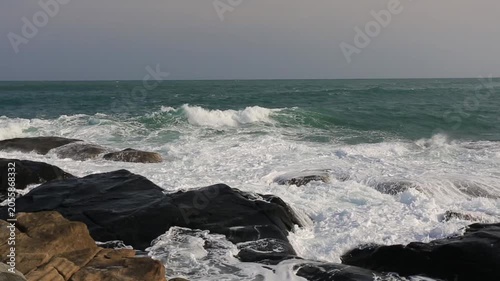 The scenery of huge waves crashing against the rocks