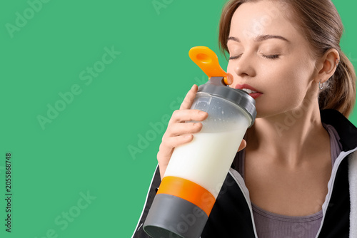 Sporty young woman drinking...