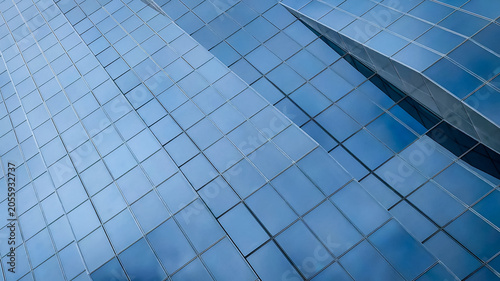Modern glass facade of a tall skyscraper building with abstract geometric architectural details in Vienna Austria corporate business district