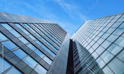 Modern business office building skyscrapers with glass facades looking up into bright blue sky background in Vienna Austria