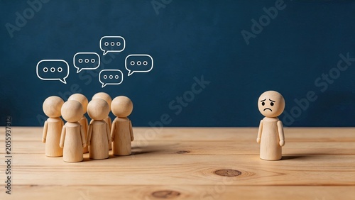 Sad wooden figure isolated from group, social exclusion and loneliness concept, bullying or rejection in community, mental health awareness, feeling left out, emotional isolation,