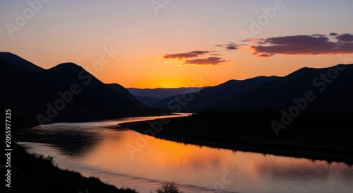 Sunset reflecting on winding river in mountain valley