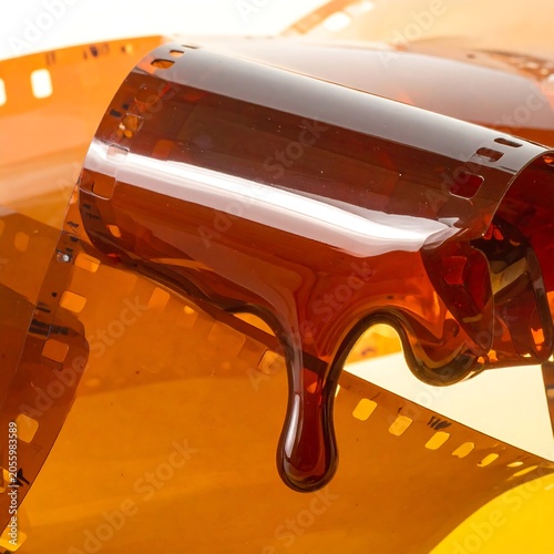 Honey dripping from film strip closeup.
