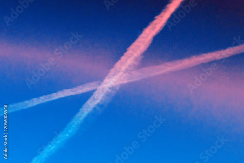 Contrails in the blue sky on a summer day