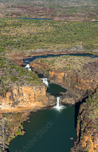 Aerial view of the Mitchell River and the Mitchell River Falls as the decend from the Mitchell Plateau to the lower section of the Mitchell River in the Mitchell River National Park.