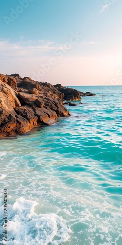 Turquoise waters lap gently against the shore, sand, coastline