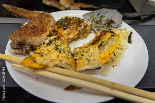 Foto teppanyaki grilled chicken with okonomiyaki slices served on plate