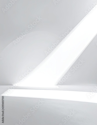 A minimalist interior space illuminated by a diagonal beam of light.