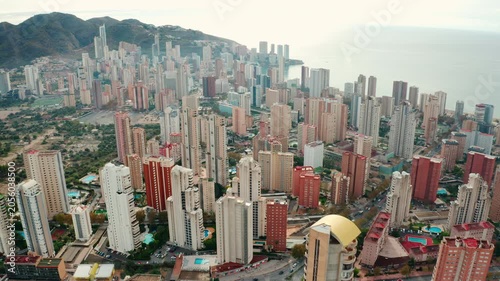 Benidorm sandy beaches, coastal promenade, and tall skyscrapers. Mediterranean seaside city famous for tourism, sunshine, and nightlife.