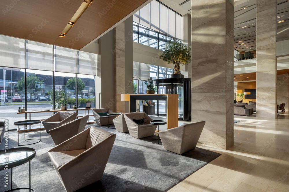 Naklejka premium Luxury hotel lobby interior with modern armchairs and big glass windows