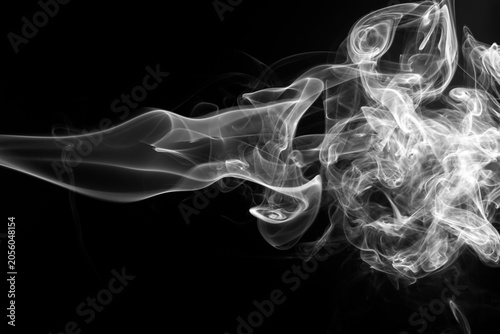 White smoke abstract shape swirling on a solid black background.
