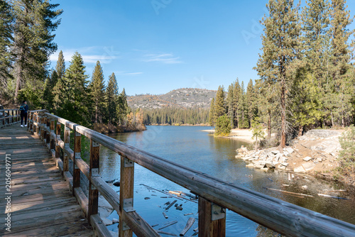 Wooden Boardwalk along Hume Lake with Pine Forest and Mountain View Sierra Nevada