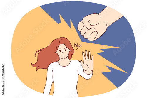 Foto Woman says no to domestic violence and makes stop gesture, standing near fist of wants to strike