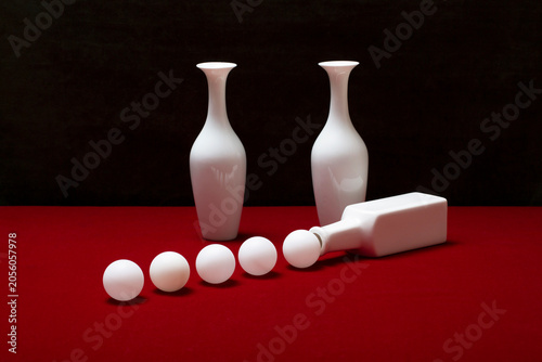 Foto Still life with white vases on a table with a red coverlet
