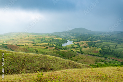 Lush Green Rolling Hills and Distant Lake Under Cloudy Sky, Banswara, Udaipur, Rajasthan