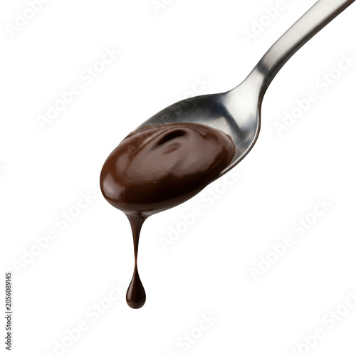Liquid dark chocolate syrup dripping from a spoon isolated transparent
