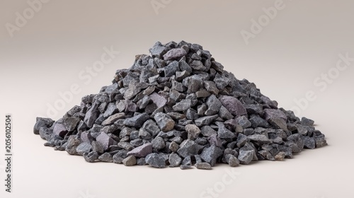 A large pile of dark gray crushed rocks isolated on a neutral background