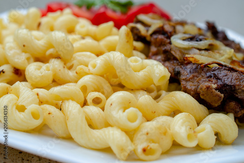 Obraz na plátne Comfort food meal with macaroni pasta and beef stew, hearty home cooking for dinner, delicious lunch plate with meat and noodles