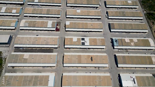 Top Down flyover Aerial Drone View of Industrial Warehouses and Logistics Infrastructure