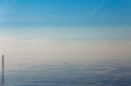 Planier lighthouse and seabirds, over hazy Mediterranean Sea off Marseille
