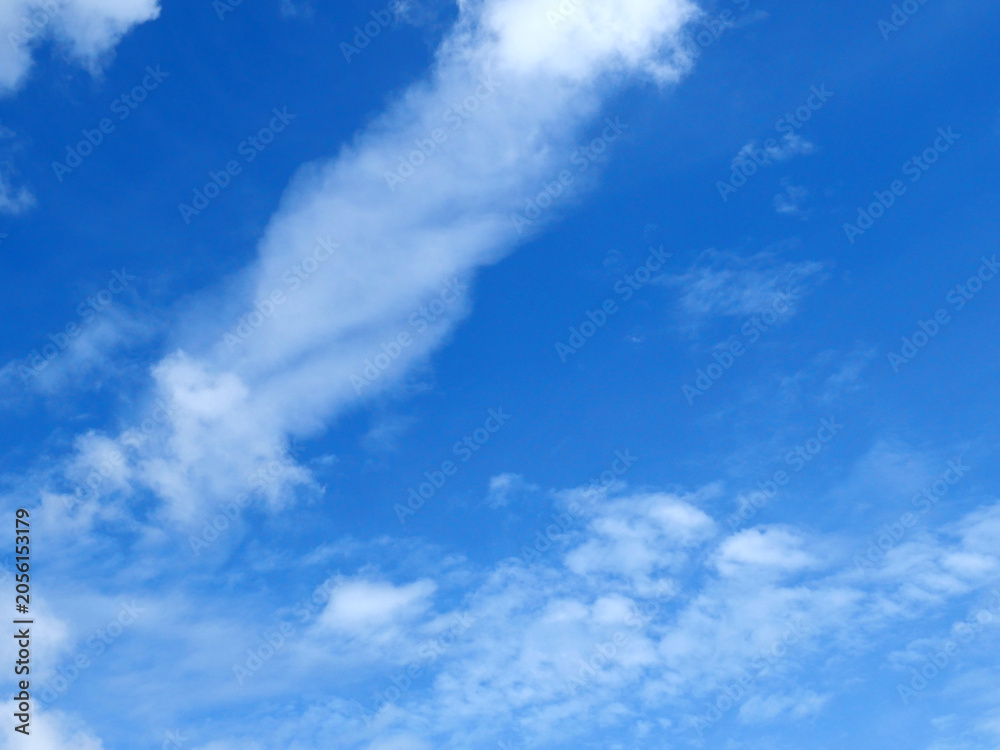 Fototapeta premium A bright blue sky background with beautiful clouds; a bottom-down, wide-angle view.