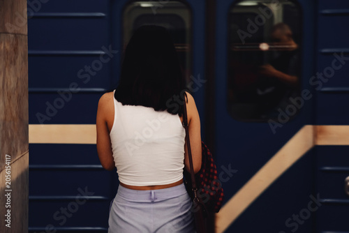 Young Woman Waits for Metro Train in a Megalopolis Underground