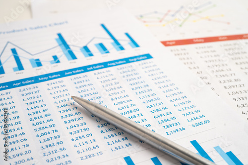 Magnifying glass on spreadsheet and graph paper. Financial data economy, Business.