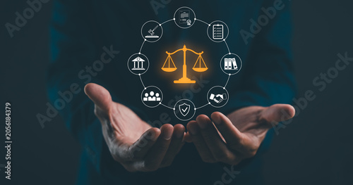 Canvas Print Two hands hold a glowing scale of justice icon surrounded by law-related symbols connected in a circular network on a dark background