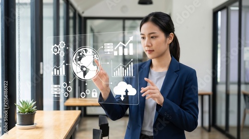 Asian businesswoman interacting with virtual screen displaying global economy, cloud computing and growth charts in modern office representing big data analysis technology.