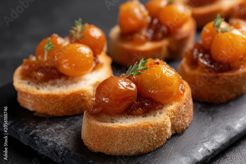Caramelized grape appetizer toasted bread gourmet snack elegant party food sweet topping fresh thyme closeup rustic golden color delicious Caramelized grape appetizer toasted bread with sweet