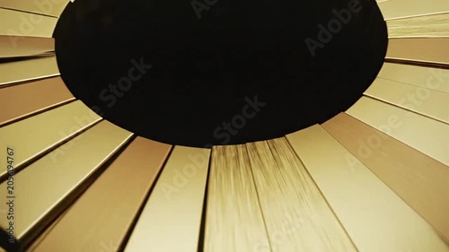 A circular arrangement of metallic golden rectangular panels forms a radial pattern