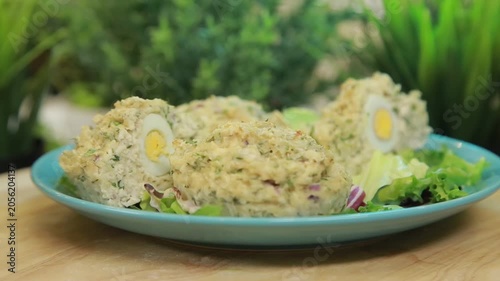Baked fish muffins plated and served on a dish with fresh lettuce leaves