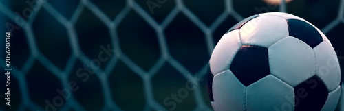 Spinning Soccer Ball on Evening Pitch with Blurred Goal Net
