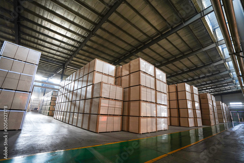 The finished board products are stacked in the warehouse workshop, in a factory in North China