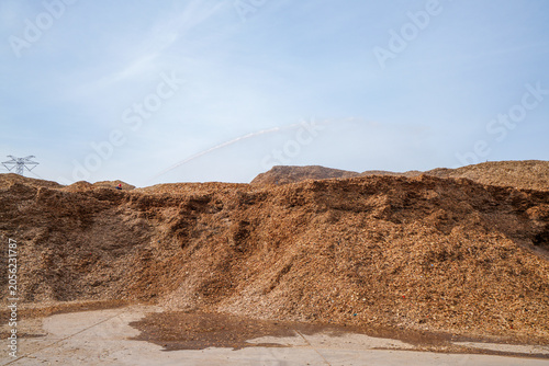 Wood chips and raw materials are piled together in a factory in North China