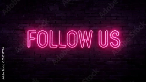Bright pink neon sign follow us glowing and flickering against dark empty brick wall background. Social media marketing and promo concept